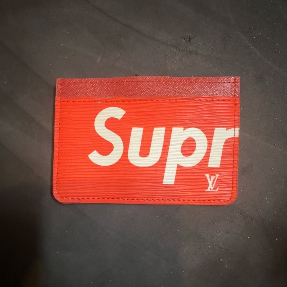 Red card holder styled as Louis Vuitton x Supreme